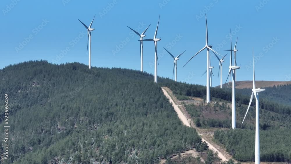 Rotating wind turbines standing on a hill in Portugal. Rotating wind turbines standing on a hill in Portugal.