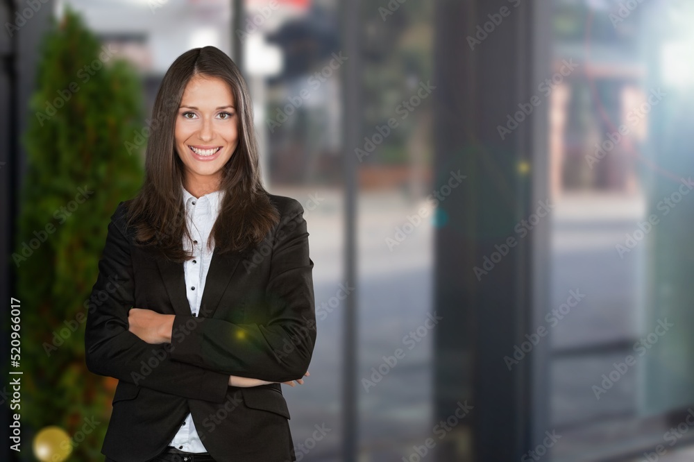 Happy attractive young businesswoman standing alone Happy attractive young businesswoman standing alone