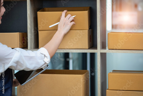 Businesswoman checking online for delivery to customers. photo