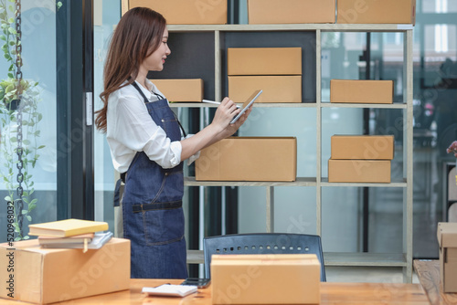 Businesswoman checking online for delivery to customers.