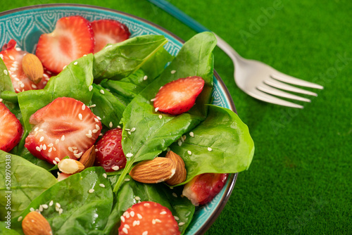 Diet food dish. Strawberry salad with spinach and almonds.