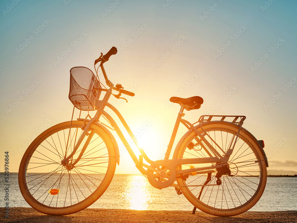 Bicycle parked on the seaside promenade on beach, vacation in summer.