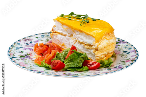 Scrambled eggs layered with salmon and fresh vegetables. Breakfast.