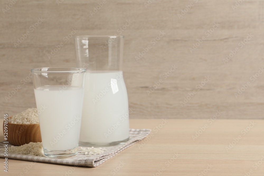 Natural rice water and grains on wooden table. Space for text Natural rice water and grains on wooden table. Space for text