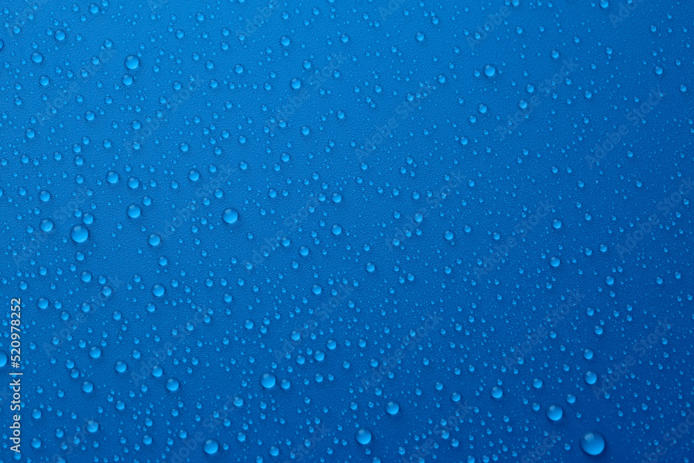 Water drops on blue background, top view Water drops on blue background, top view