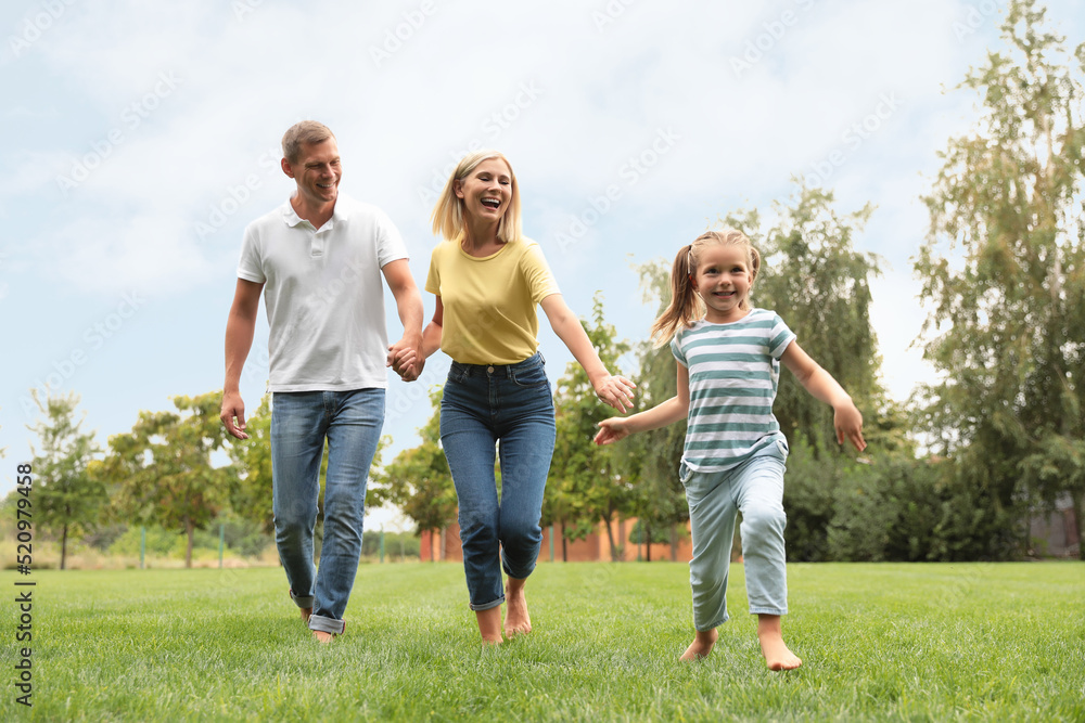 Happy family running in park on summer day Happy family running in park on summer day