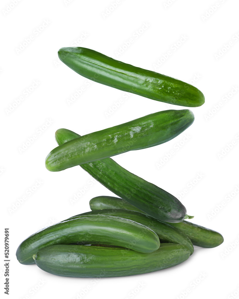 Fresh green cucumbers falling on white background Fresh green cucumbers falling on white background