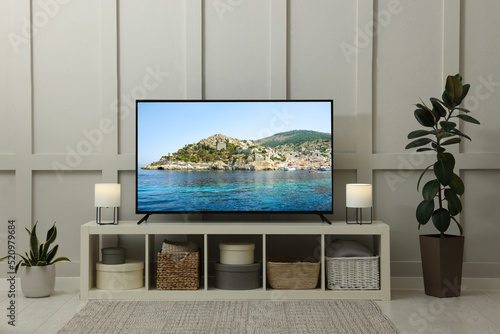 Fotografie Modern TV set on wooden stand in room