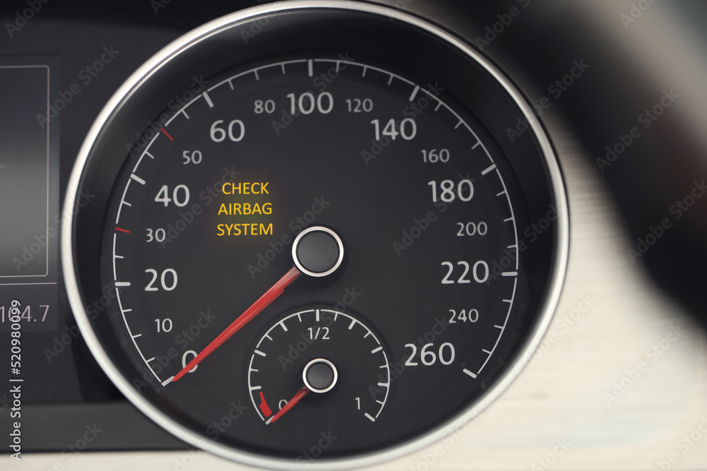 Closeup view of dashboard with warning icon check airbag system in car
