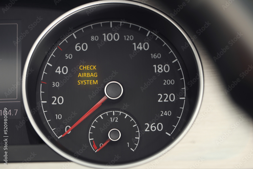 Closeup view of dashboard with warning icon check airbag system in car Closeup view of dashboard with warning icon check airbag system in car