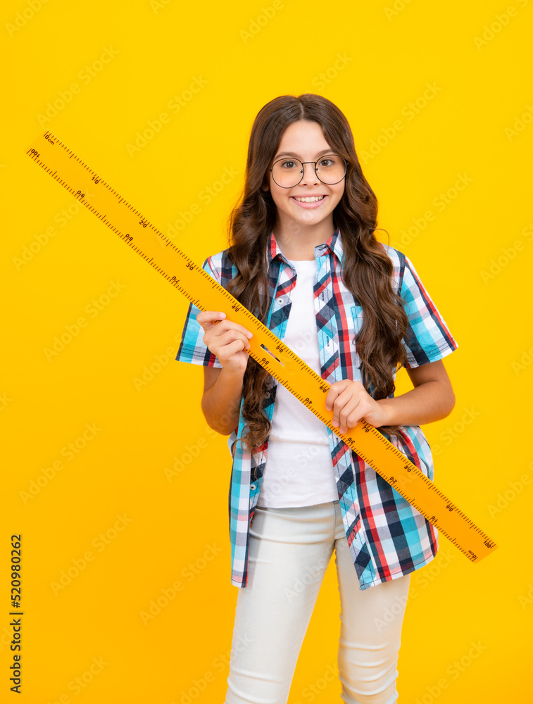 Teenager child school girl holding measure for geometry lesson. Measuring height. Measuring equipment. Kid student study math. Knowledge day. Teenager child school girl holding measure for geometry lesson. Measuring height. Measuring equipment. Kid student study math. Knowledge day.