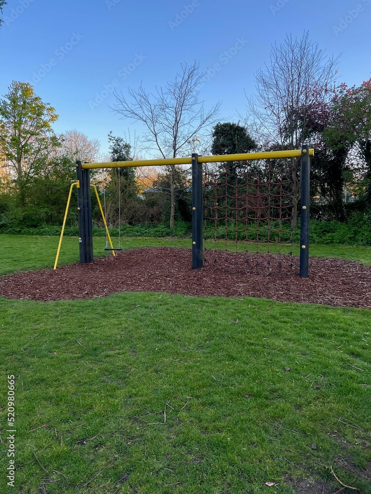 Swing and climbing net on children's playground in park Swing and climbing net on children's playground in park