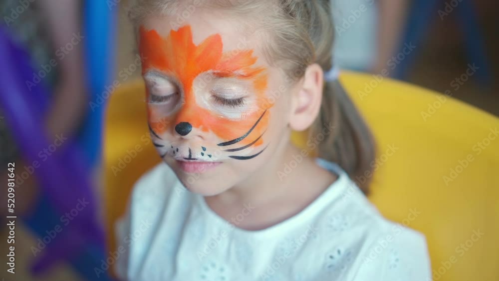 Children face painting. Artist painting with brash and special body
