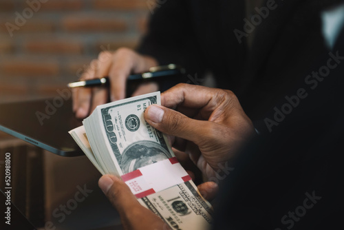 Business team using a tablet and computer to analysis graph company financial in office.