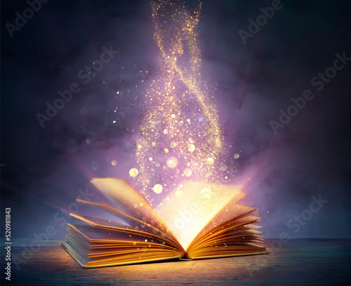 Fotografering Magic Book With Open Pages And Abstract Lights Shining In Darkness - Literature