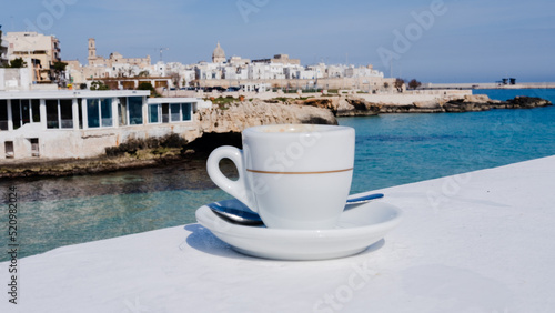 Fotografie cup of coffee on the bottom view of Monopoli, Puglia. Italy
