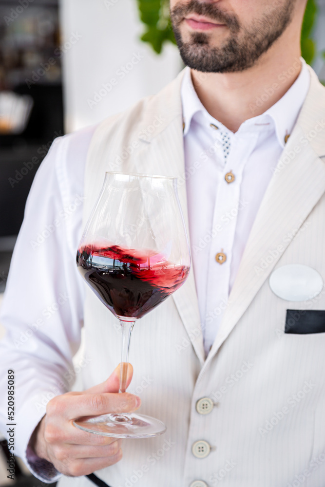 Man holding a glass of wine Man holding a glass of wine