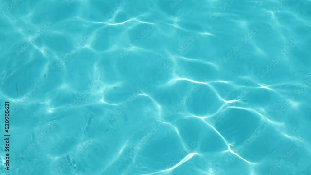 Blue rippled water in swimming pool background Blue rippled water in swimming pool background
