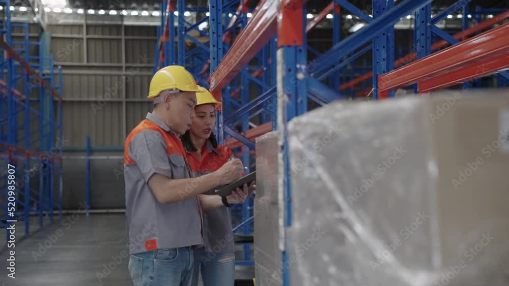 Two warehouse workers inspect the goods before they are shipped or distributed. Working in a warehouse or industrial plant. Two warehouse workers inspect the goods before they are shipped or distributed. Working in a warehouse or industrial plant.