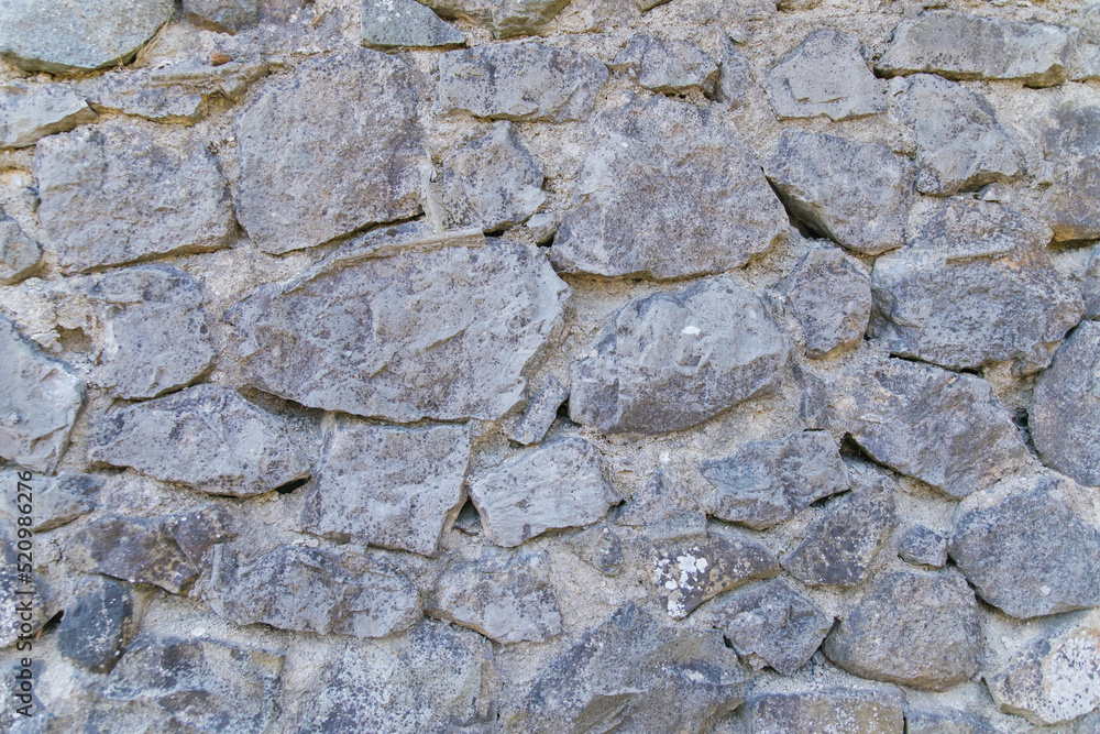 The wall is gray.Abstract background.The texture of a stone wall. A stone wall. The wall is gray.Abstract background.The texture of a stone wall. A stone wall.