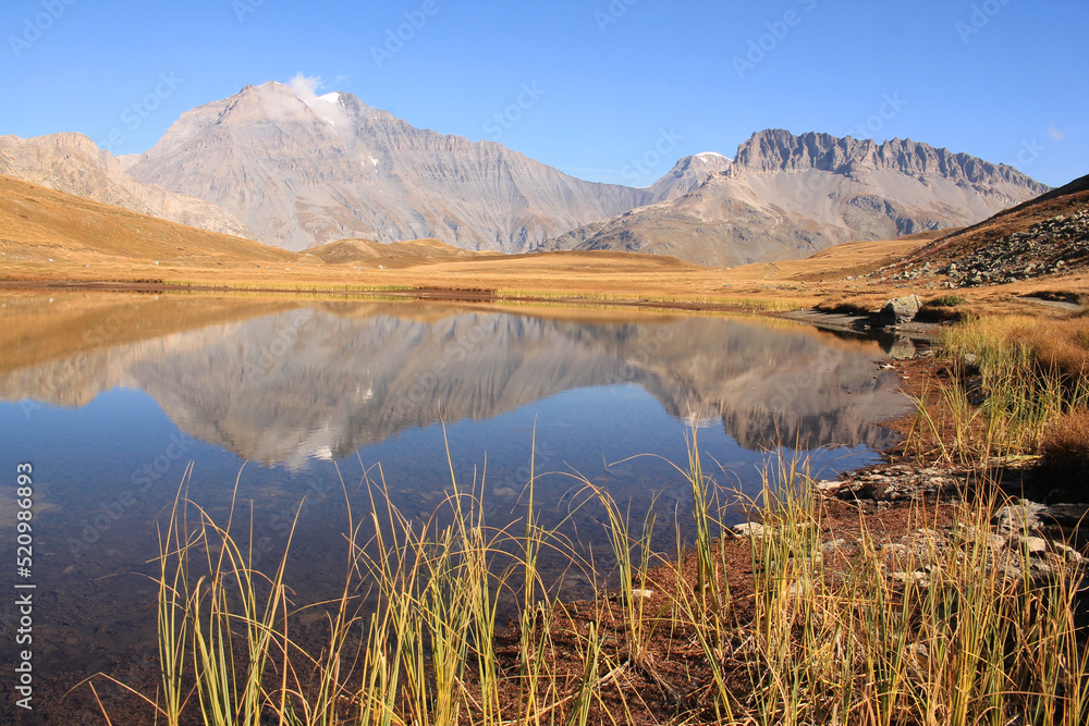 Amazing reflections in lake Plan du Lac Bellecombe looking towards La Grande Casse in the French alps