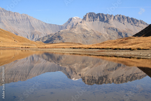 Amazing reflections in lake Plan du Lac Bellecombe looking towards La Grande Casse in the French alps photo