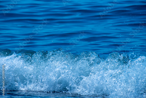 Ocean waves crashing on sandy beach. Sea waves breaking on shore.