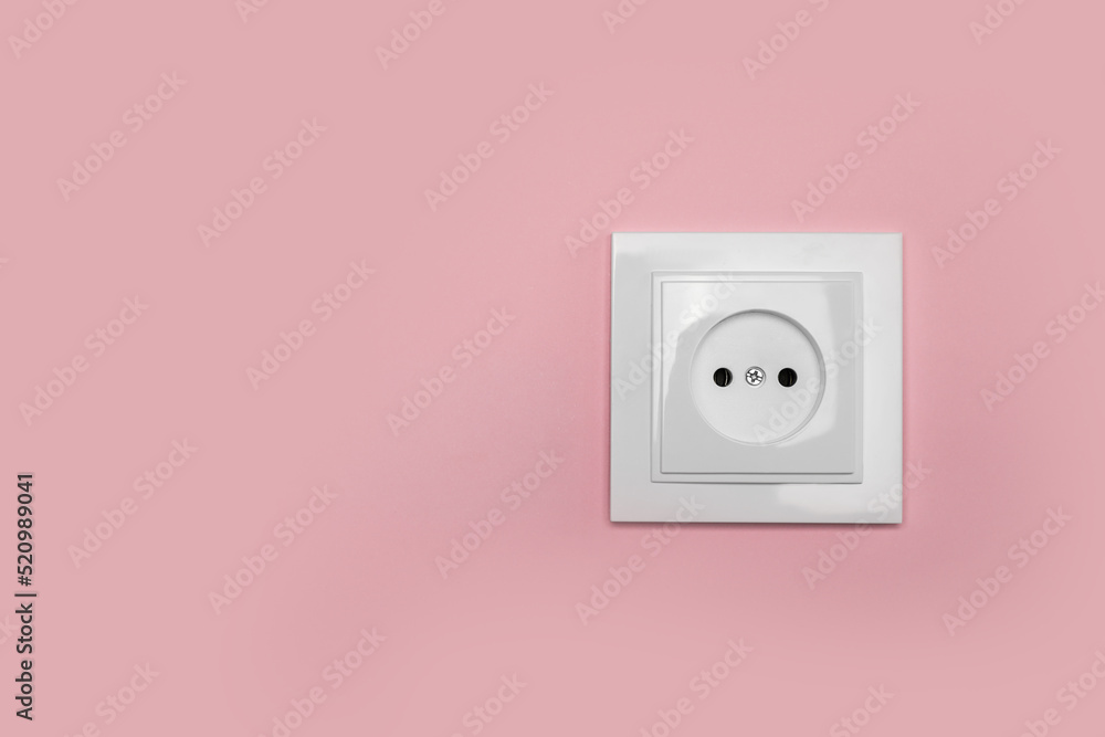 Power socket on pink wall, space for text. Electrical supply Power socket on pink wall, space for text. Electrical supply
