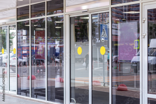 Supermarket automatic glass doors with camera sign closeup photo