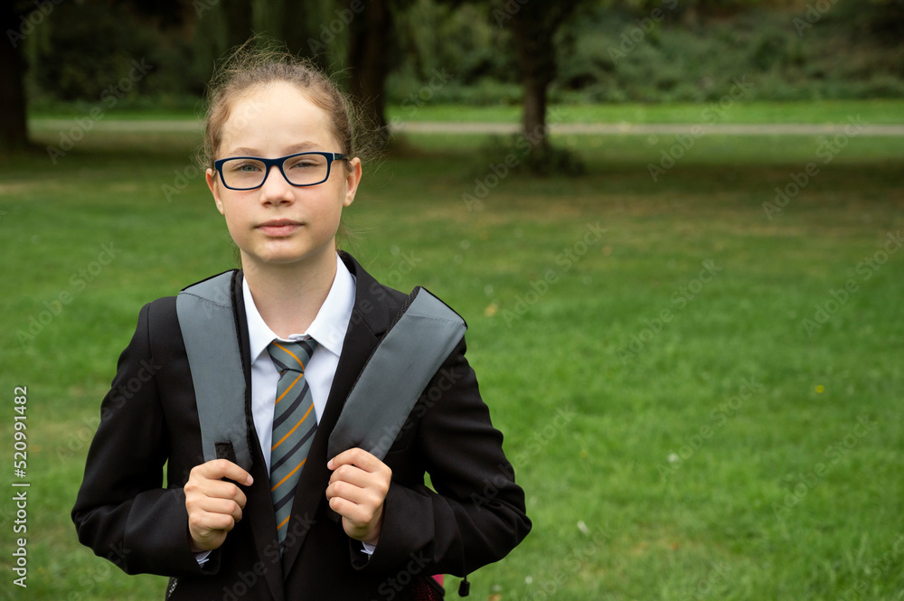 Teen age girl outdoor, wearing formal school uniform, with bagpack Teen age girl outdoor, wearing formal school uniform, with bagpack