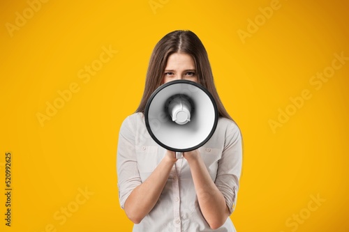 Young smiling expressive happy student woman screaming shouting hot news in megaphone