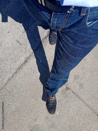 Male walking outside on the street.
