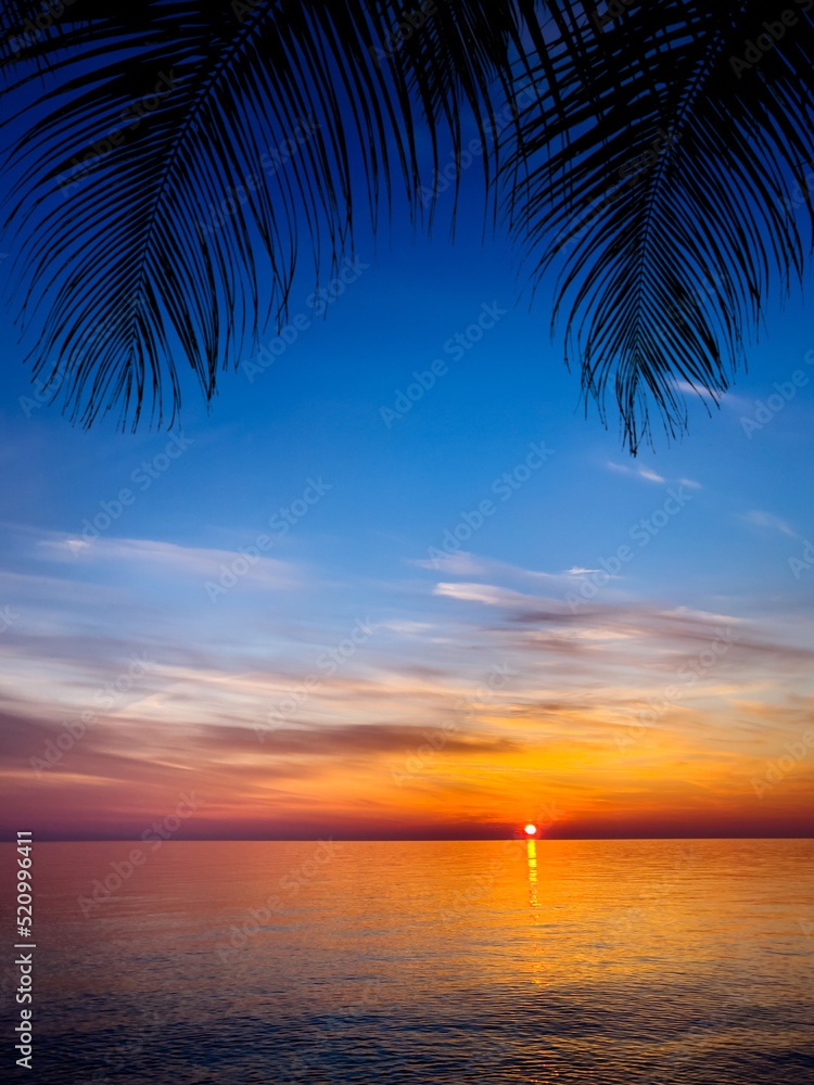 Silhouette of palm trees Beautiful sunset on the tropical sea beach