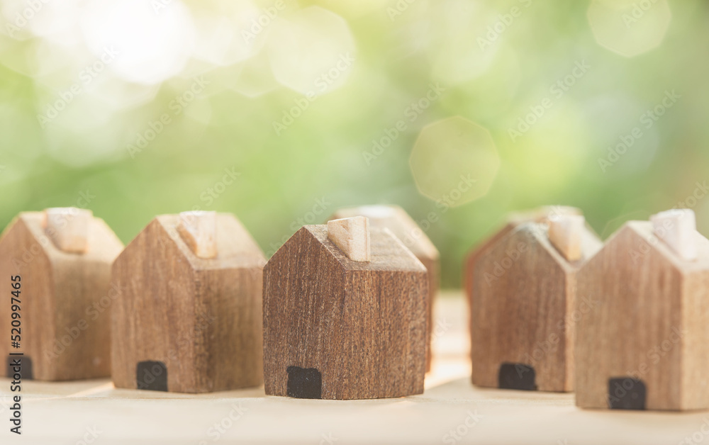 Wooden village on the table And have space to build a new house. planning savings money of coins to buy a home concept for property, mortgage and real estate investment and saving for a house.