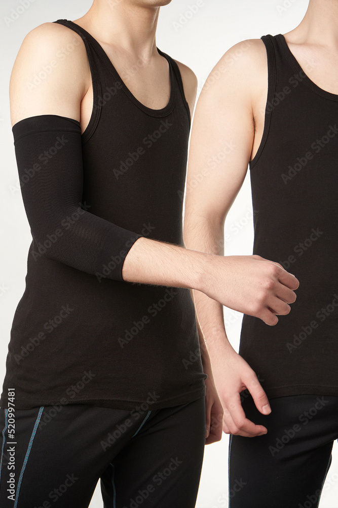 Cropped double shot of a man in a black tshirt and sweatpants. The boy