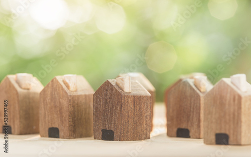 Wooden village on the table And have space to build a new house. planning savings money of coins to buy a home concept for property, mortgage and real estate investment and saving for a house.