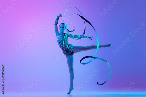 Obraz na plátně Portrait of one young rhythmic gymnast posing with ribbon in her hand isolated o