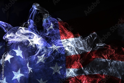 USA flag in flowing smoke. Abstract American flag on dark background photo