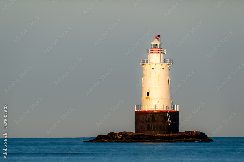 07/10/2022 - Little Compton, RI USA - Early morning image of the Sakonnet Point Light (West Island Light) between Little Compton and Tiverton Rhode Island, at Sakonnet River and Atlantic Ocean.	