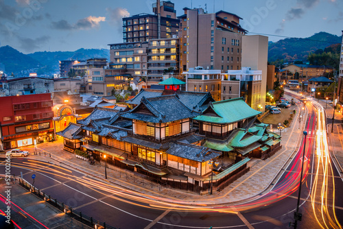Matsuyama, Japan downtown skyline at Dogo Onsen bath house at twilig
