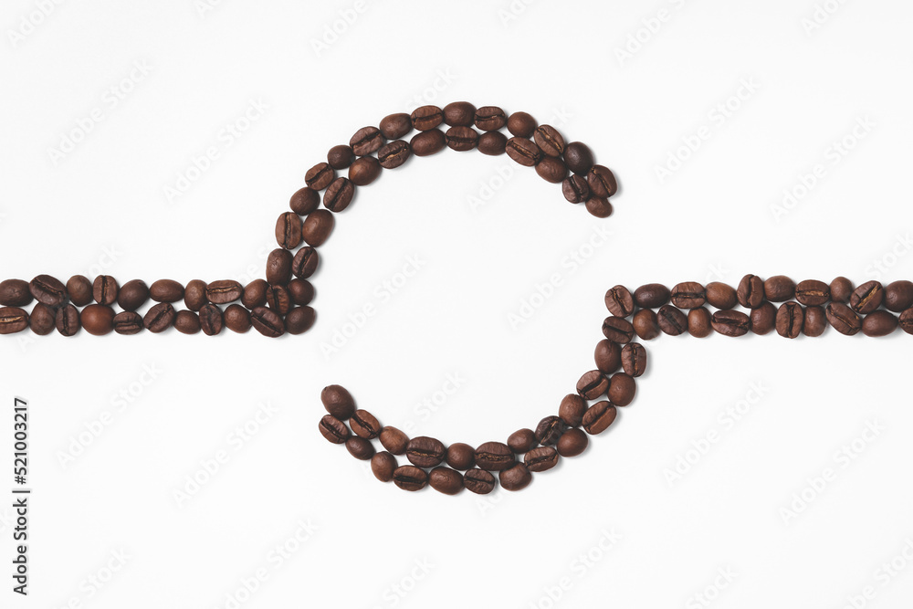 Composition of coffee beans in the form of a line with a circle in the center in a flat lay. The concept of making a drink. Top view with copy space. Composition of coffee beans in the form of a line with a circle in the center in a flat lay. The concept of making a drink. Top view with copy space.