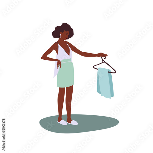 Black woman chooses what to wear with pants on a hanger in her hands. Cartoon flat vector illustration. Daily routine. 