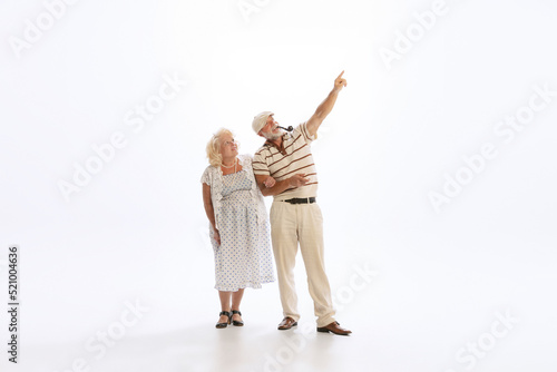 Canvas Print Portrait of retro style dancers, senior man and woman in vintage attire dancing swing isolated on white background
