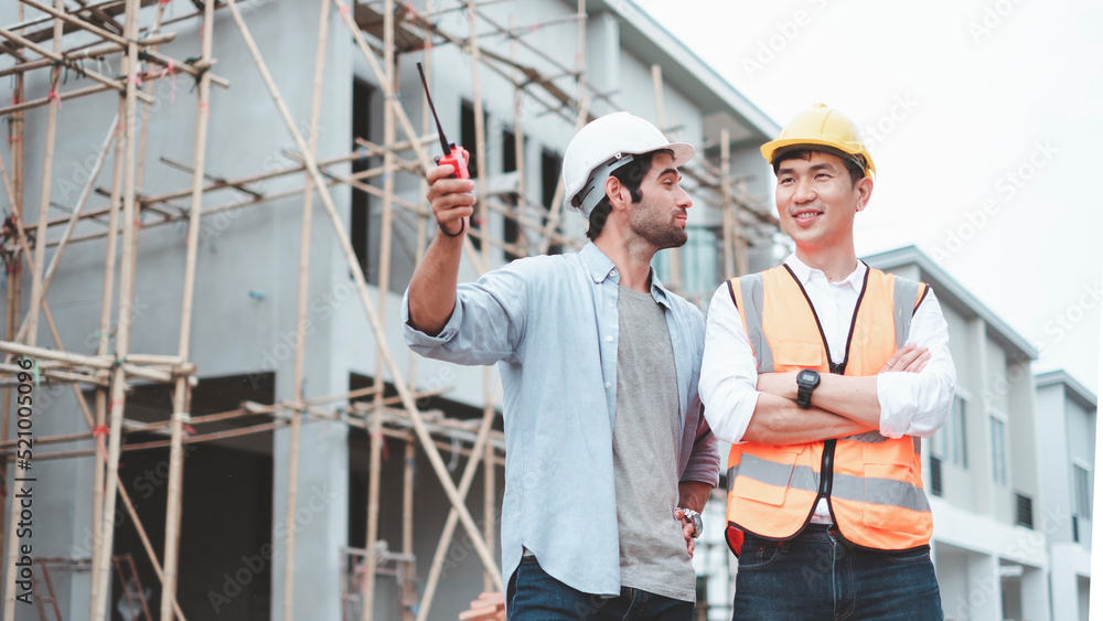 Construction worker at building site. Architecture engineering at workplace. engineer architect wearing safety helmet meeting at contruction site. foreman presenting project showing work. Construction worker at building site. Architecture engineering at workplace. engineer architect wearing safety helmet meeting at contruction site. foreman presenting project showing work.