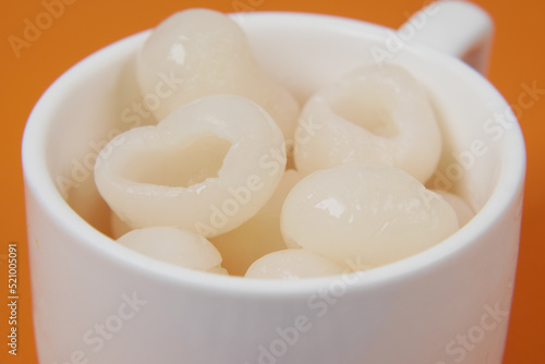 longans fruits in a white cup on table 