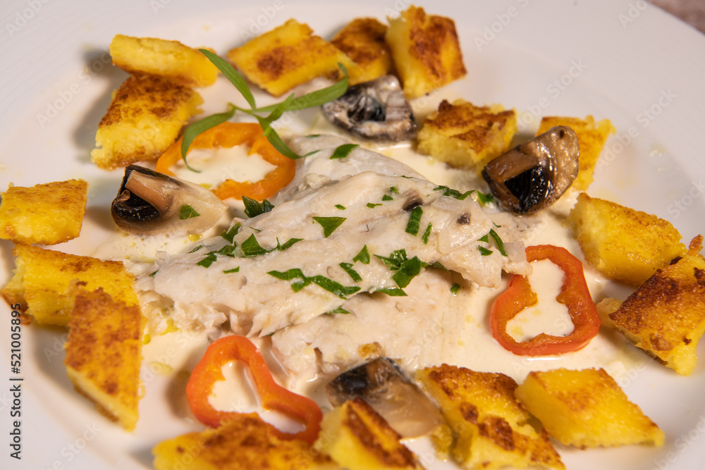 Recipe for sea bass fillet with fried polenta and white wine sauce. High quality photo