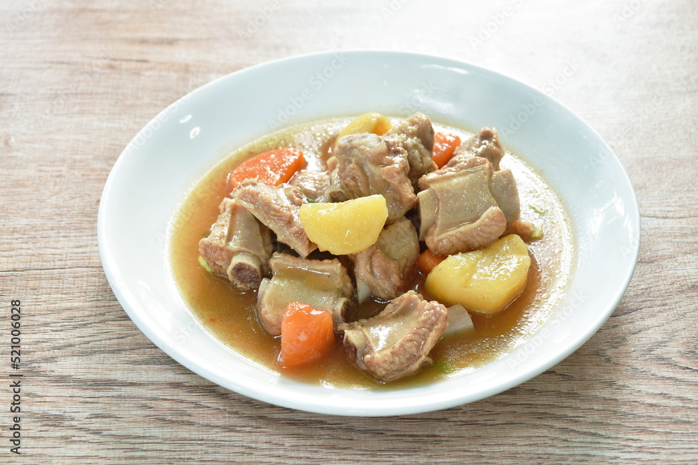 boiled pork bone with potato and carrot stew on plate boiled pork bone with potato and carrot stew on plate
