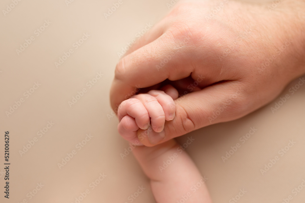 newborn baby holding father's finger. hand of a newborn baby. finger. baby handshake newborn baby holding father's finger. hand of a newborn baby. finger. baby handshake
