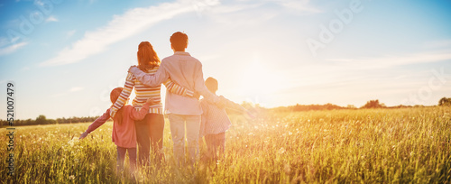 Happy family in the nature together on the evening sunset photo