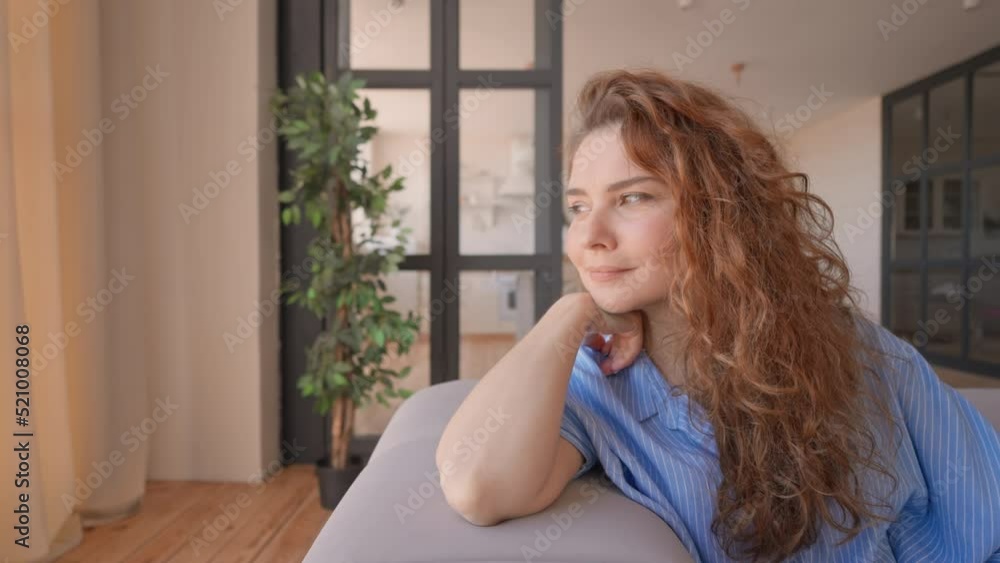 successful woman enjoy day at home sitting on the couch looking through the window dreaming relaxing in the morning successful woman enjoy day at home sitting on the couch looking through the window dreaming relaxing in the morning